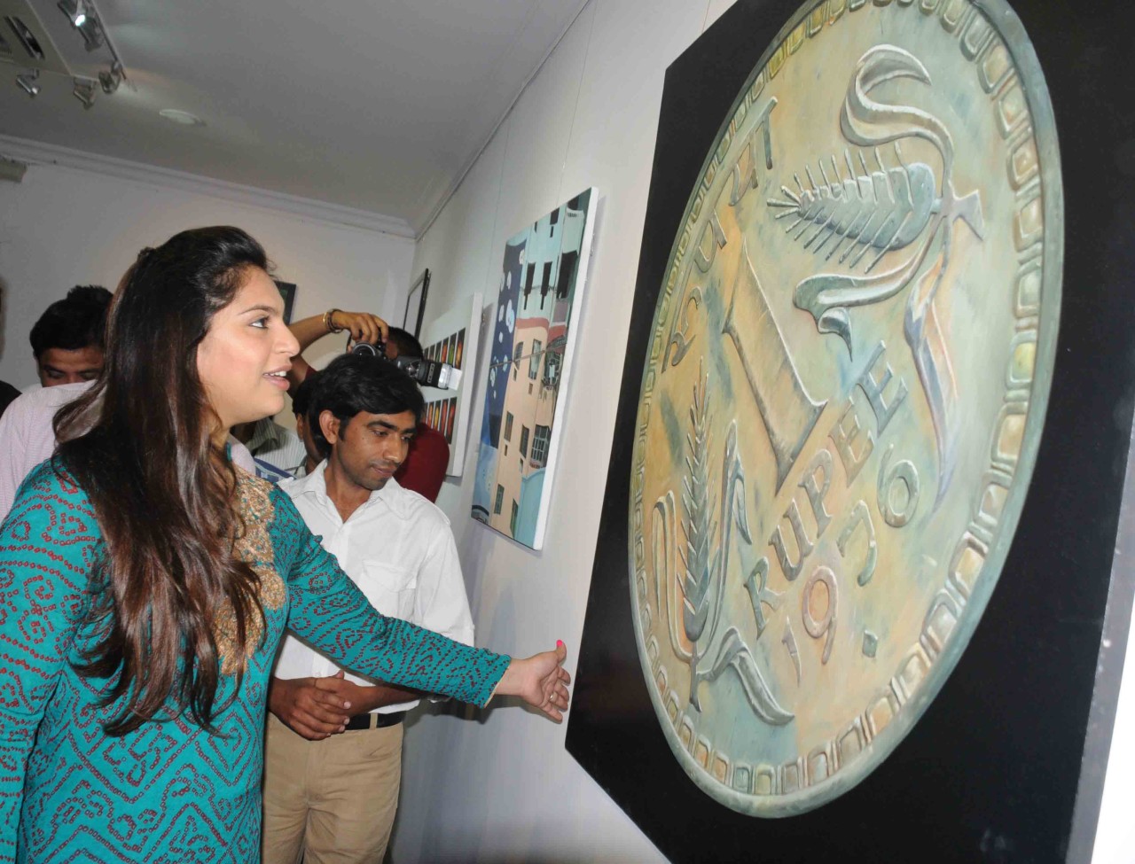 Upasana Kamineni going round the painting exhibition at JNTU Hyderabad on Friday.Express Photo.